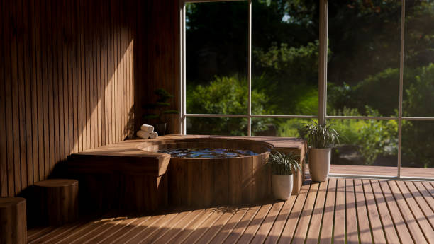 Beautiful and luxury Onsen spa room in Japanese style with wood bath against the glass wall stock photo