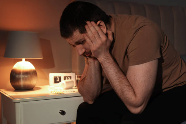 istock Man suffering from insomnia in bedroom at night 1450966206