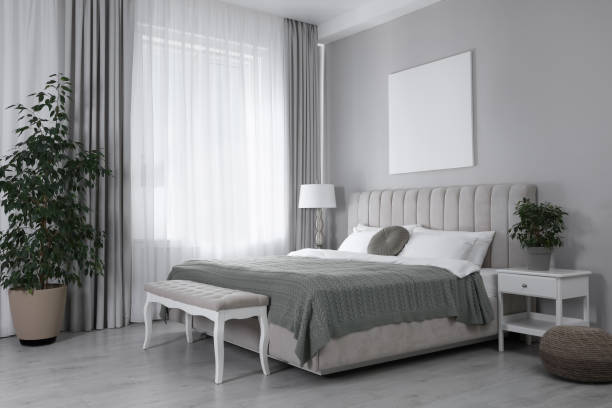 istock Blank canvas on wall in stylish bedroom interior. Space for design 1450966214
