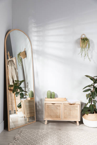 istock Stylish hallway room interior with wooden commode and large mirror 1450966278