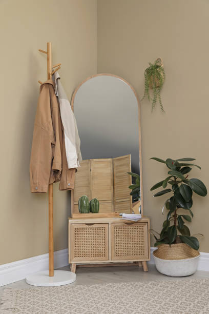 istock Stylish hallway room interior with wooden commode, coat rack and large mirror 1450967057