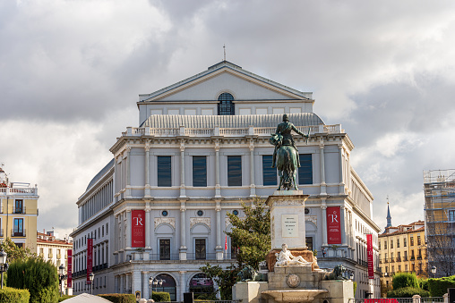 Madrid, Spain - Dec 10th, 2022: The Royal Theatre (Teatro Real, 1850) in Orient Square (Plaza de Oriente) with the bronze statue of King Philip IV (Felipe IV or Felipe el Grande), Madrid downtown, community of Madrid, Spain, southern Europe.