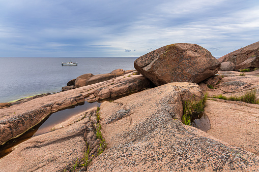 Baltic Sea coast with rocks and ship on the island Blå Jungfrun in Sweden.