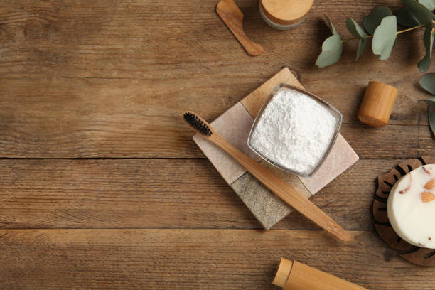 istock Flat lay composition with tooth powder and eucalyptus on wooden table, space for text 1450970027