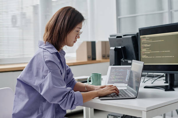 istock Young woman typing codes on laptop 1450970058