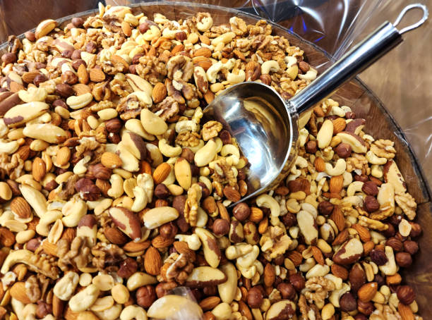 Full bowl of different kinds peanuts, nuts and seeds stock photo