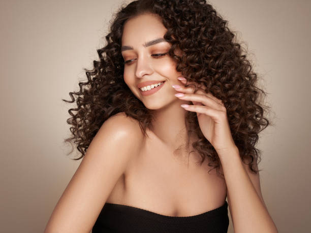 istock Beautiful smiling woman with afro curls 1450972042