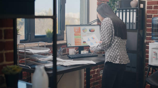 istock Close up of woman analyzing charts documents on desk 1450974610