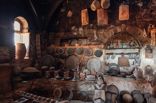 Kalambaka - Greece. July 11, 2022: Typical kitchen of historic medieval Great Meteoron Monastery with all utensils and blackened ceiling. Meteora