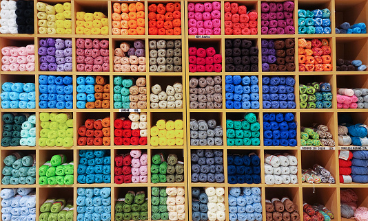 Store shelves packed with colorful yarn for knitting