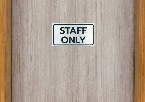 Warning sign in front of the door with a message for staff only