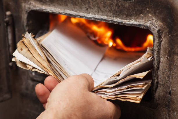 istock Throwing old papers into the heating boiler 1450982130