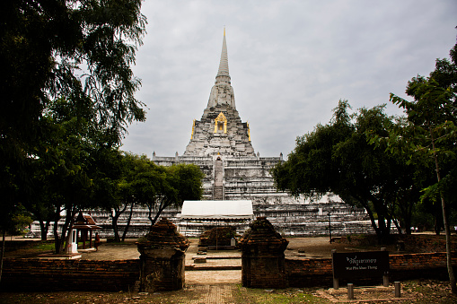 Ancient stupa Phukhao Thong antique ruin chedi for thai people travel visit respect praying blessing buddha holy wish mystery myth at Wat Phu Khao Thong temple on November 6,2022 in Ayutthaya Thailand
