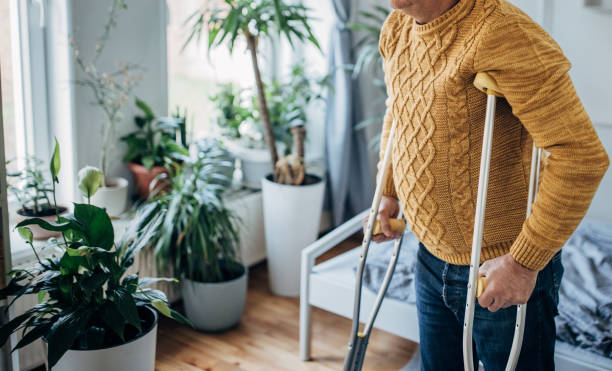 istock Disabled person with crutches 1450986081