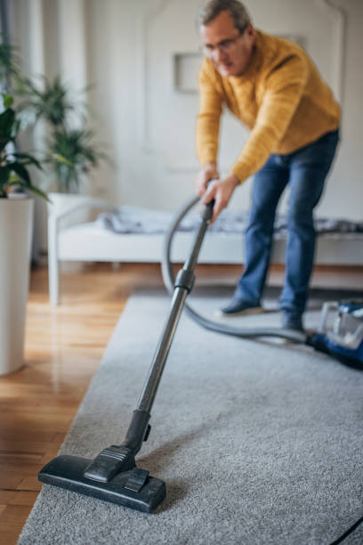 istock A senior uses a vacuum cleaner 1450986220