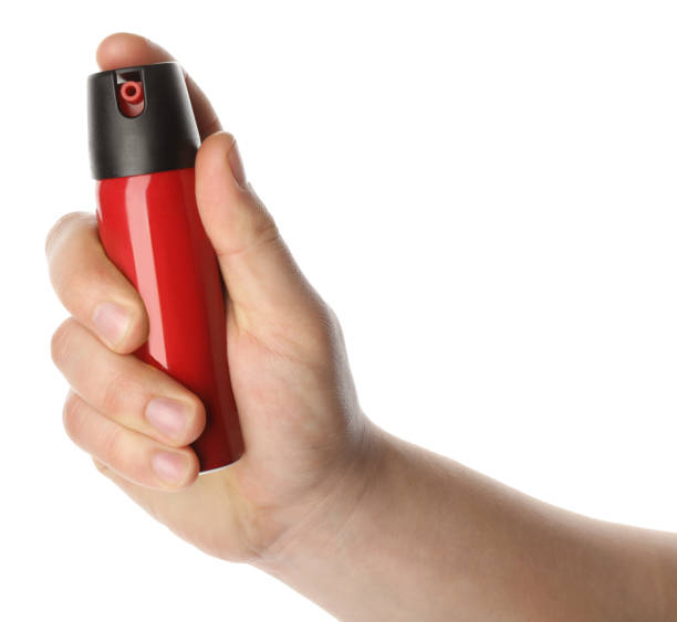 istock Man holding pepper spray on white background, closeup 1450995250