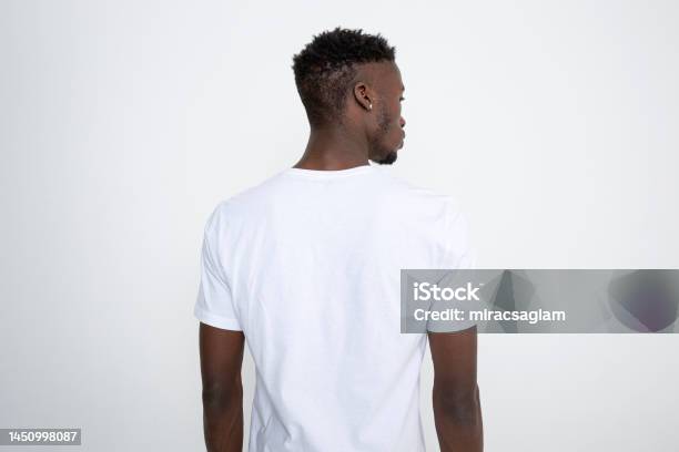 Africanamerican Man In White Tshirt Against White Background Stock Photo - Download Image Now