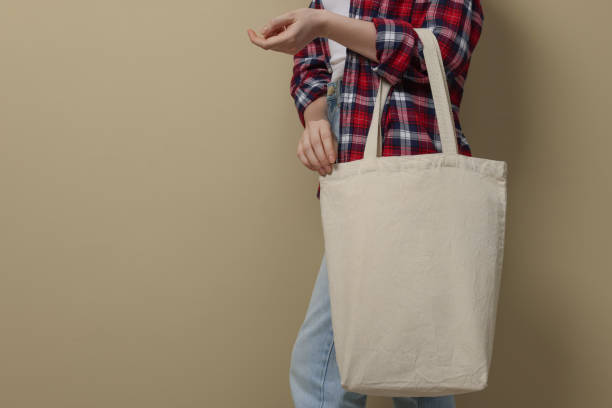 istock Woman with eco bag on beige background, closeup. Space for text 1451001034