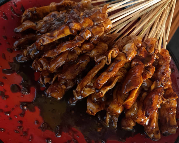 istock Raw chicken satay that has been smeared with soy sauce is ready to be grilled 1451001087
