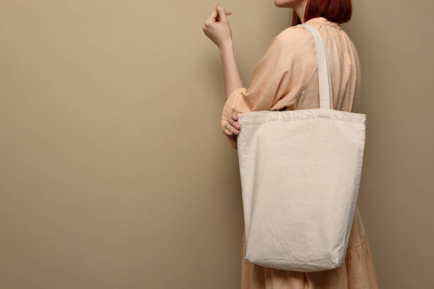 istock Woman with eco bag on beige background, closeup. Space for text 1451001158
