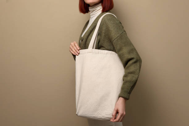 istock Woman with eco bag on beige background, closeup. Space for text 1451001300
