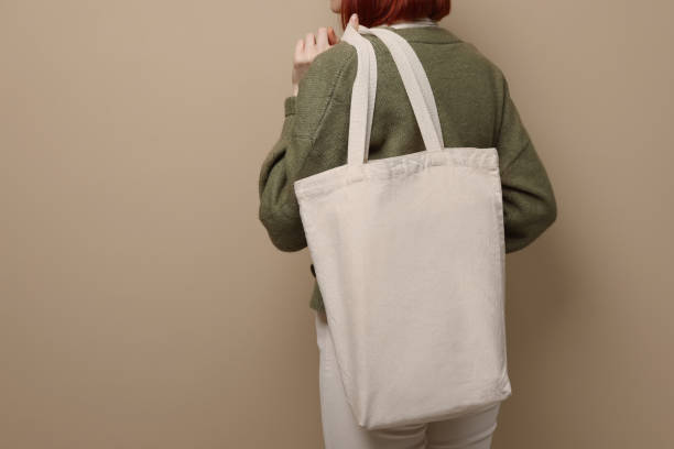 istock Woman with eco bag on beige background, closeup. Space for text 1451001388