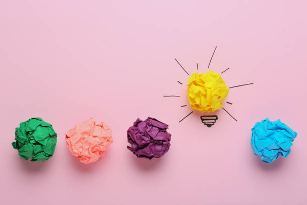 istock Composition with crumpled paper ball as lamp bulb on pink background, flat lay. Idea concept 1451001773