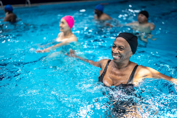 istock Senior woman exercising at swimming pool 1451002059