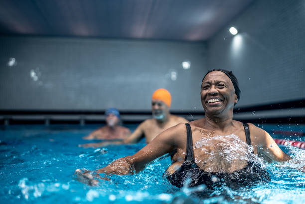 istock Senior woman exercising at swimming pool 1451002077