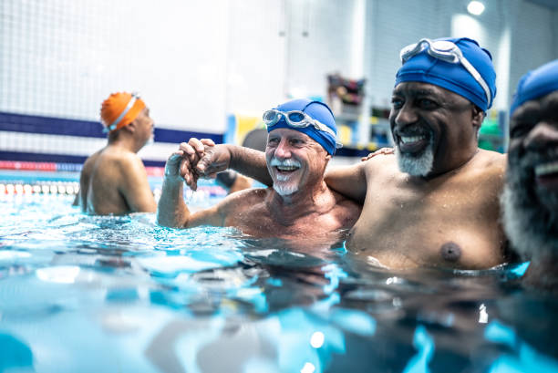 istock Senior men hugging at swimming pool 1451002200