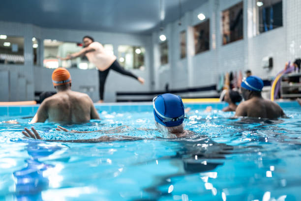 istock Senior people exercising at swimming pool 1451002329