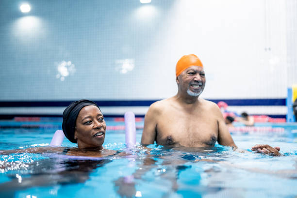 istock Senior friends talking at swimming pool 1451002998