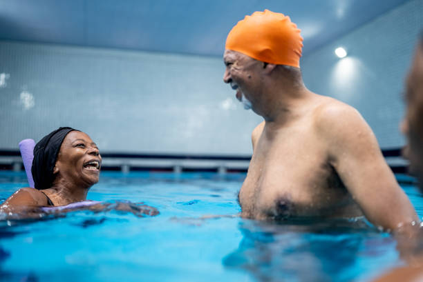 istock Senior friends talking at swimming pool 1451003011