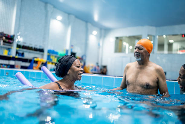 istock Senior friends talking at swimming pool 1451003584