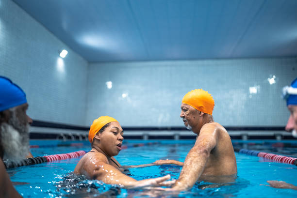 istock Senior man learning to swim in the swimming pool 1451006222