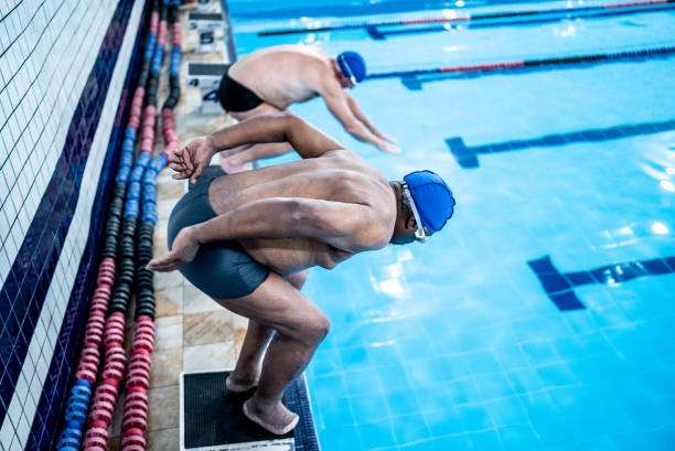 istock Senior men diving in the swimming pool 1451007562