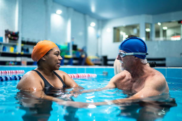 istock Senior man learning to swim in a swimming pool 1451008060
