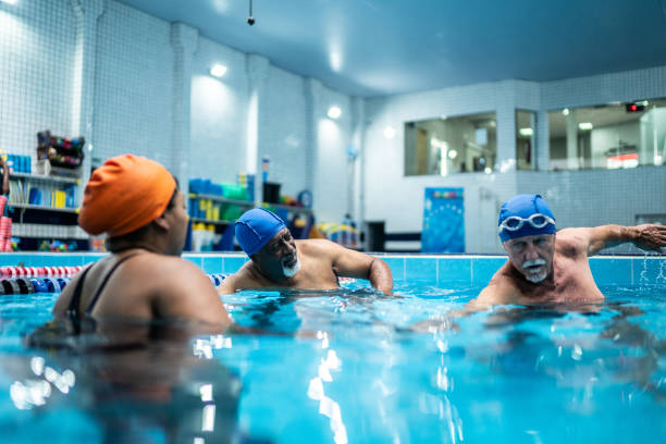istock Senior men learning to swim in a swimming pool 1451008223
