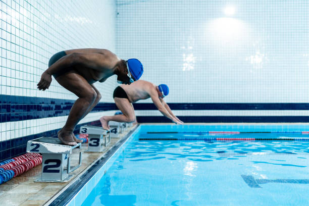 istock Senior men diving in the swimming pool 1451008292