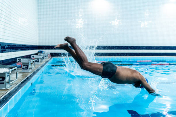 istock Senior men diving in the swimming pool 1451008296