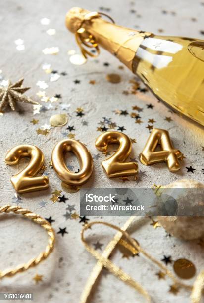Golden 2024 New Year Numbers With Confetti And Champagne Bottle Stock Photo  - Download Image Now - iStock