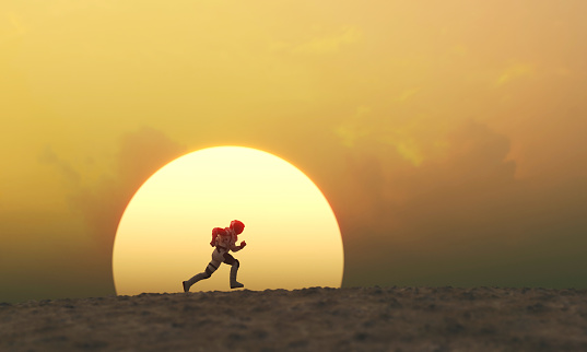 Astronaut running during sunset at a remote planet