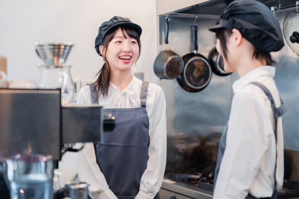 istock A woman working part-time in a restaurant happily learning about her duties 1451020121