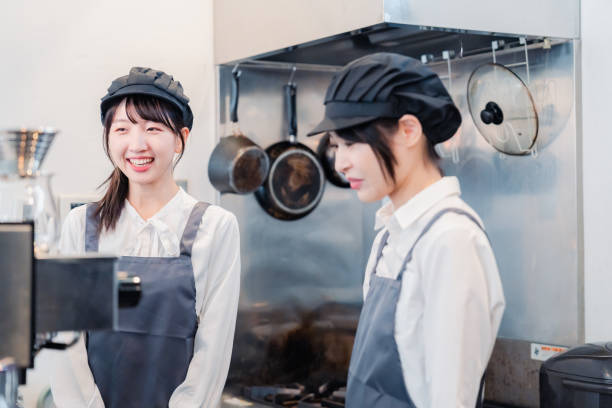 istock A woman working part-time in a restaurant happily learning about her duties 1451020130