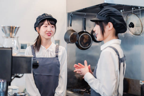 istock A woman working part-time in a restaurant happily learning about her duties 1451020140