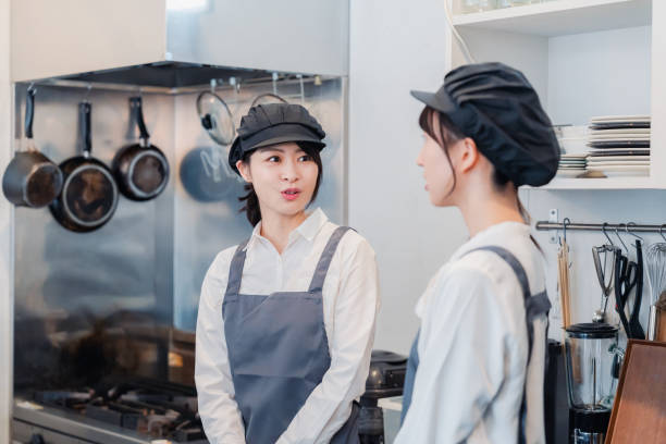 istock A woman working part-time in a restaurant happily learning about her duties 1451020708