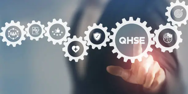 QHSE-Quality Health Safety Environment. Safety and health at workplace concept. Maximize value by successfully implementing QHSE management system. Businessman touching on QHSE and smart background.