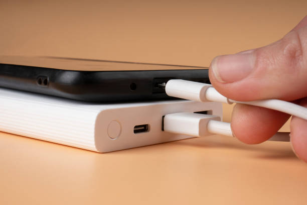 istock phone charging with power bank, extra battery for smartphone via usb 1451024122