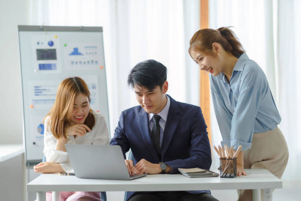 istock Group of young Asian business people with the creative work, talk and exchange ideas shared at the meeting. 1451029964