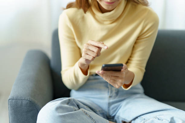 istock Woman using smartphone to send text , work or play social media. 1451029990